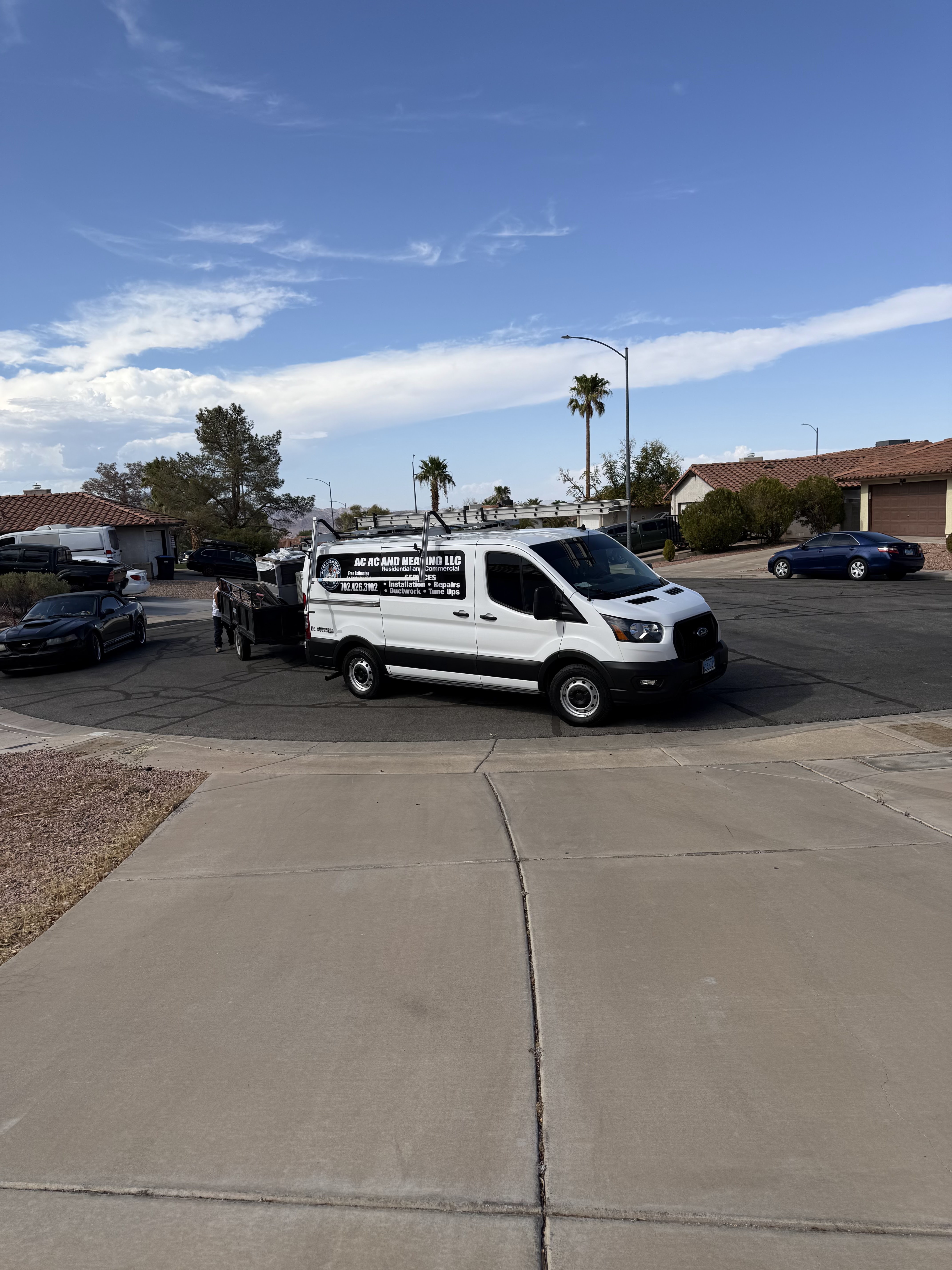 AC AC and Heating service van on a residential street