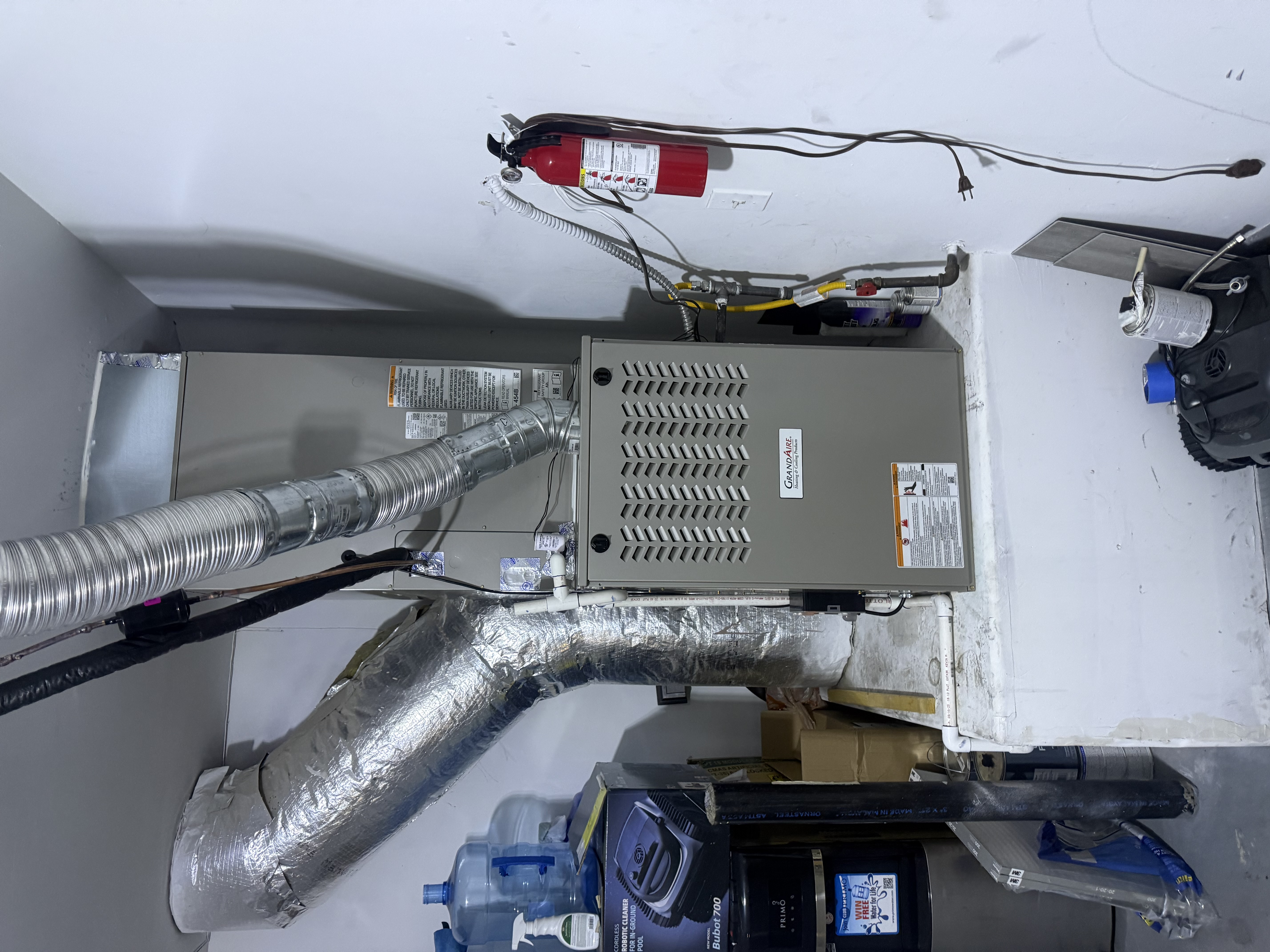 Indoor furnace with connected ductwork and metal vent pipe