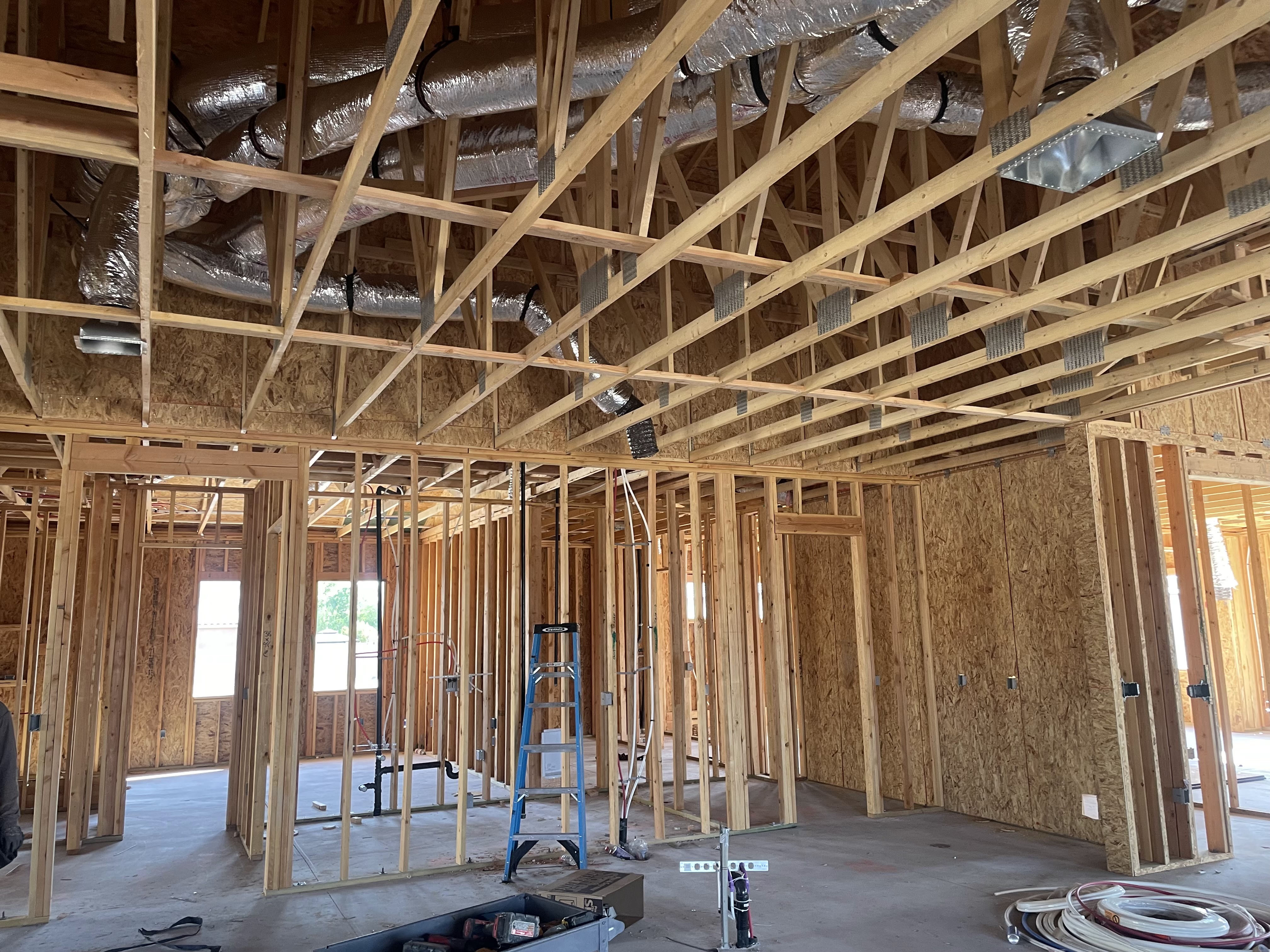 Insulated HVAC ductwork above wood framing in a new construction project